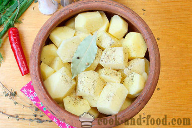 Baked potatoes with chicken in a pot