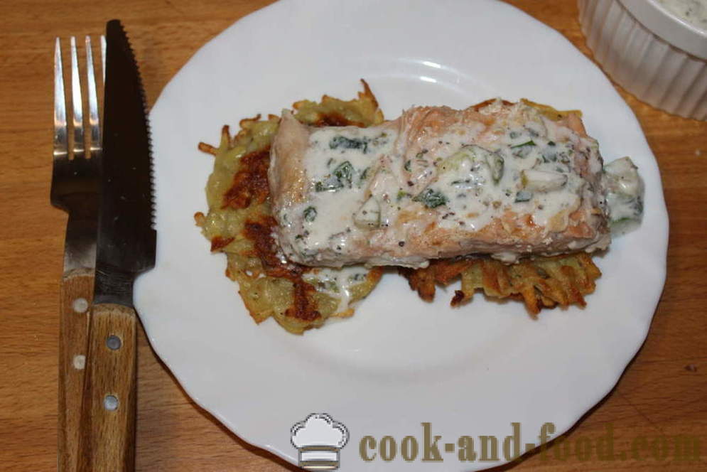 Fried potato pancakes and salmon fillet in a creamy sauce